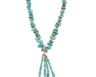 235
A Puebloan-Style Turquoise Necklace
Mid-20th century; Southwestern United States
A single strand of turquoise nuggets suspending a pair of turquoise, shell and coral jaclas, with silver cone clasp and heishi spacers
25" L x 6.5" H
147.4 grams gross
Estimate: $300 - $500