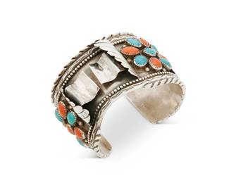 265
A Grace Touchine Navajo Silver And Set Stone Watch Cuff Bracelet
Grace Touchine (1952-2005, Diné)
Late 20th/21st century
Stamped: G.T.
A heavy sterling silver watch cuff with cluster set turquoise and coral and with applied floral and feather motifs and incised and stamped edges
7.5" total inner C x 2" H, with a 1.25" gap
156.4 grams gross
Estimate: $400 - $600