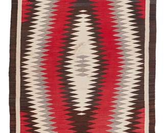 117
A Navajo Regional Rug
Mid-20th century, Diné
With a radiating serrated diamond motif woven in red, cream, grey and dark brown wool
61" H x 41.5" W
Estimate: $300 - $500