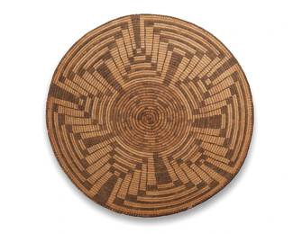 56
A Large Pima Basketry Tray
Early/mid-20th century, Akimel O'odham; Southwest United States
A coiled tray with a stepped concentric star motif radiating from center
5.5" H x 18" Dia.
Estimate: $800 - $1,200