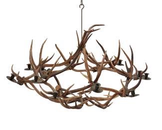 205
A Stag Horn Deer Antler Chandelier
Early/late 20th century
Carved into one antler: H55
The circular hanging ceiling fixture composed of deer antlers with twelve blackened metal candle holders
27.25" H x 52" Dia.; Including hook: 34" H
Estimate: $800 - $1,200