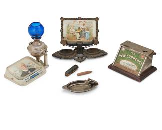 210
A Group Of Tobacco Paraphernalia
Late 19th/early 20th century
One marked: Charles Derby Cigar / Made Right Taste Right; another marked: F.F.V. / My Favorite Smoke For Sixty Years; another marked: The New Currency / P. Lorillard Co. Makers / Donovan & Bressler Distributors / Williamsport, PA; another marked: Pommery Sec and Champagne Nature (Vin Brut) / Compliments of Henry Atkins & Co
Comprising three tabletop cigar cutters and a cigar lamp lighter with blue glass shade and a rolling tray, 4 pieces
Lamp: 8.75" H x 10.75" W x 6.25" D
Estimate: $400 - $600