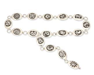 248
A Bernard Dawahoya Hopi Pueblo Silver Link Pictorial Belt
Bernard Dawahoya (c. 1935-c. 2011, Second Mesa)
Mid/late 20th century
Each concho stamped with artist's snow cloud cipher
A sterling silver overlay link belt with oval conchos designed with various figural motifs including birds, antelope, rabbits, antelope, sheep, bear, spider, butterfly, lizard, and frog
Belt: 44.25" L; Each concho: 1.5" H x 2" W
343.0 grams
Estimate: $1,000 - $1,500