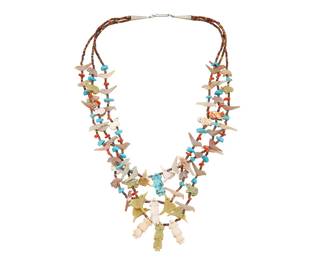 236
A Zuni Pueblo-Style Multistrand Carved Fetish Necklace
Mid/late 20th century, Southwestern United States
Appears unmarked
A three-strand carved multistone and shell fetish necklace with kachina figures, bears, and birds including hummingbirds, all in graduated sizes and with silver cone clasp
27" L
Estimate: $400 - $600