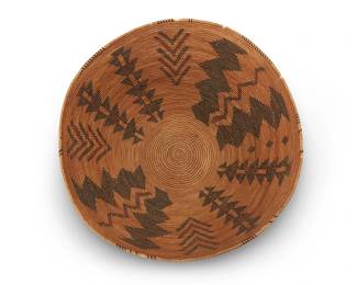 57
A Large Polychrome Yokuts Basket
Early/mid-20th century; Central California
A coiled large bowl with rim ticking and nine columns of alternating zigzags, stacked arrowheads, and chevron motifs
8" H x 15.5 " Dia.
Estimate: $700 - $900