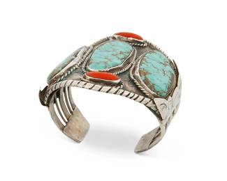 267
A Large Southwest Turquoise And Coral Cuff Bracelet
Mid-20th century
Appears unmarked
A large three-wire sterling silver cuff with three slab turquoise stones and branch coral all set to an oxidized silver plaque and with five-wire terminals
6.75" total inner C x 3.25" H, with a 1.25" gap
127.9 grams gross
Estimate: $400 - $600