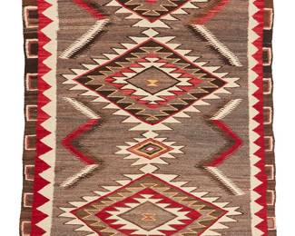 111
A Navajo Red Mesa Rug
Early/mid-20th century, Diné
Woven in grey, brown, cream, red, tan, and yellow wool with a central column of graduated serrated diamonds with a complex stepped border on two sides
76" H x 54.5" W
Estimate: $700 - $900