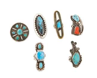 278
A Group Of Southwest Silver And Stone-Set Rings
Six works:

Allen Pooyouma (1922-2014, Hopi Pueblo)
Mid/late 20th century
Each stamped with corn motif cipher for Allen Pooyouma; further stamped: Sterling
Comprising two sterling silver rings, including a long oval ring with shadowbox set turquoise (Ring size: 7; 2.375" H) and an unusual "watch" ring with two set turquoise stones (Ring size: 7.5; 2.25" H), 2 pieces

Four Southwest silver, mixed metal and stone-set rings
Mid/late 20th century
One marked: JL [roughly]
A group of rings in various designs and sizes, most with set stones including turquoise, coral, and shell, 4 pieces
Largest: ring size: 9; Smallest: ring size: 7.5

6 pieces total
113.8 grams gross
Estimate: $500 - $700