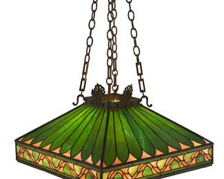 186
An Arts & Crafts Leaded Glass Hanging Light Fixture
Early 20th century
Appears unmarked
The four-light ceiling light fixture with leaded glass shade in a green foliate motif supported on four metal chains issuing from a conforming mounting plate, electrified
Shade: 12.75" H x 23" W x 23" D; Hanging height: 34.5" H
Estimate: $1,000 - $2,000