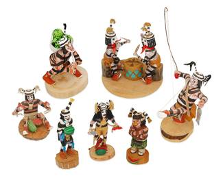 287
A Group Of Hopi Koshare Clown Figures
Mid/late 20th century
Each variously signed and dated to underside: Leon Lalo "Clown" "Hopi" / Clown by V. White / Koshare V Wood / Koshare V Wood 1179 / Hopi Clown V. Wood "92" / Clowns, Sit Down Al [illegible]
The polychrome carved wood figures, some with leather pouches and accents, comprising a figure with arms crossed by Leon Lalo (20th century, Hopi-Tewa), a standing figure holding a watermelon slice and large knife by V. White, two figures seated facing each other over a drum, a standing figure holding a single watermelon, and three V. Wood figures including one struggling with a fishing line, one with three watermelons in its knapsack, and one seated holding slices of watermelon in each hand
Largest: 7" H x 6.75" W x 6.5" D; Smallest: 6.375" H x 3.5" W x 2.5" D
Estimate: $300 - $500