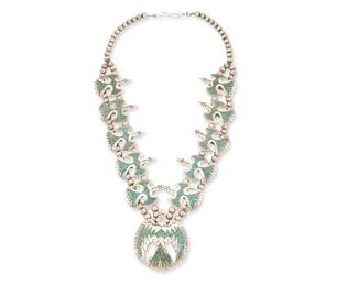 227
A Navajo Silver And Turquoise "Peyote Bird" Necklace
Late 20th century, Diné
Stamped: HC [conjoined]
A double strand sterling silver squash blossom-style necklace with ten turquoise mosaic chip inlay bird "blossoms" and a central bird naja
29.5" L x 2.75" H
237.4 grams gross
Estimate: $700 - $900