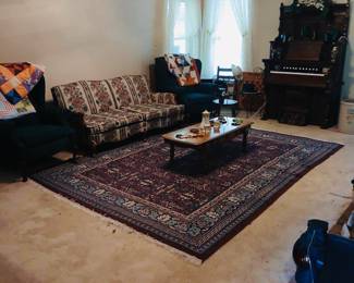 Living room furniture in two different rooms. Large rugs. Sofa chair is coffee tables.

Very old restored upright “player” organ

