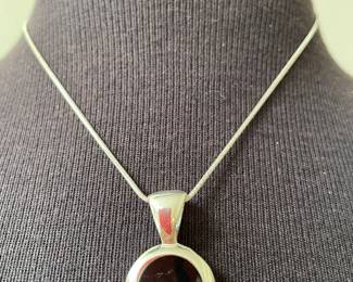 Silver Necklace with Dark Round Stone Pendant in a polished silver bezel