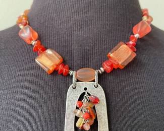 Orange and Red Necklace with a Silver Toned Pendant with Colorful Bead Insert