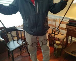 One of several antique kitchen cooking tools including tools, andirons, pots, and fire screens 