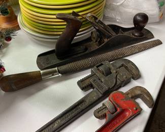 Pipe, wrenches and wood plane 