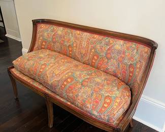 beautiful antique curved-back settee with bright paisley upholstery