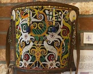 $300. An old baby carrier used by Orang Ulu women, a Sarawak tribe. Each tribe had their own way of beading, type of leather etc. with different meanings for that particular tribe such as status .