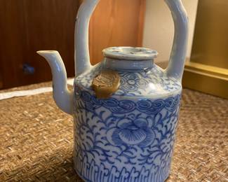 $240. Stamped blue and white teapot with foliage and floral design. Teapot is approx. 8 inches tall