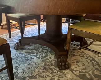 $600 Round Oak Table 57 + 18” leaves with pedestal claw feet with 3 chairs and one arm chair -Not your typical pedestal - 