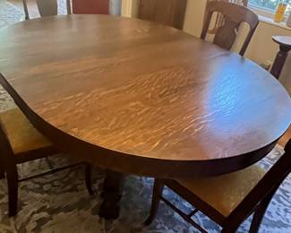 $600 Round Oak Table 57 + 18” leaves with pedestal claw feet with 3 chairs and one arm chair - Not your typical pedestal - 