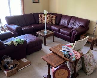 Burgundy leather sectional with matching chair and ottoman.