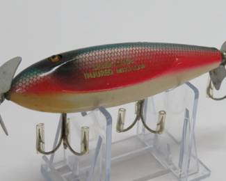 One of many wooden fishing lures, rainbow colored injured minnow