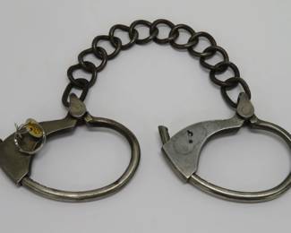 Many sets of handcuffs, shackles, and manacles