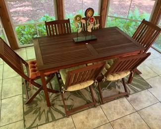 Acacia wood table with six matching chairs.