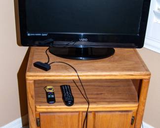 Vizio TV and small wooden TV stand 