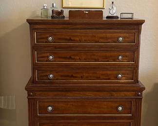 The set includes a dresser, chest of drawers, two night stands and bed.