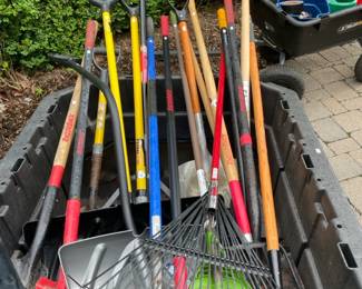 Various yard tools such as rakes and shovels with brands like Razorback and Husky