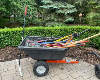 Various yard tools such as rakes and shovels with brands like Razorback and Husky, Gorilla cart