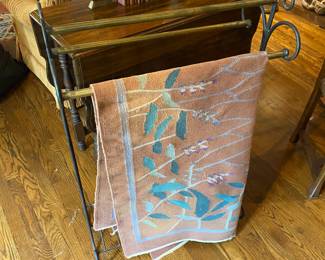 Indian blankets and brass and iron quilt rack.