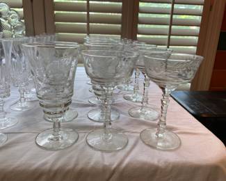 Several sets of etched glassware.