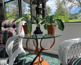 Glass top lamp table with bronze tennis player lamp base and crossed tennis rackets supporting the glass top