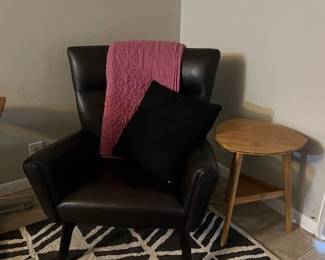 black leather sitting chair and side table