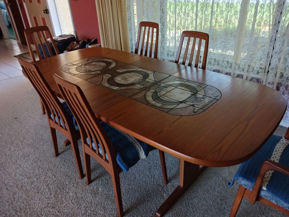 Picture shown with  table leaf in- leaf can be stored inside table when not in use, four regular chairs, two chairs with arms