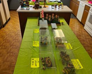 Table of finished and encased tank models with infantry 