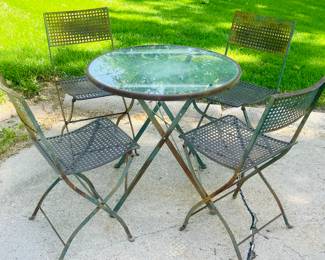Glass top patio table with 4 cast iron chairs  