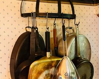 Several cast iron hanging pan storage racks are available 