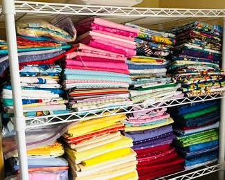 There are full TOTES AND TOTES packed full with clean and folded fabric. 