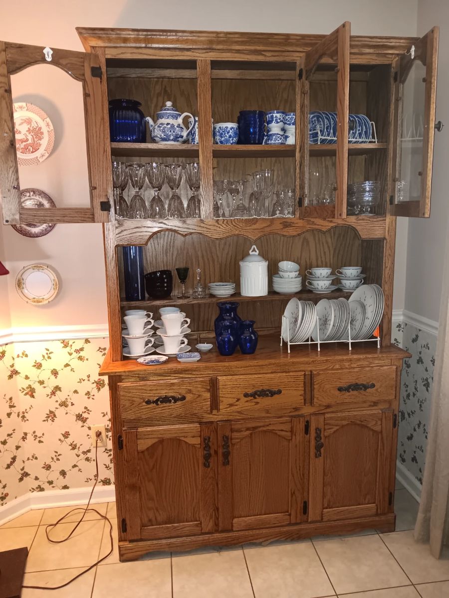 Oak cabinet, china, blue willow, crystal stems.