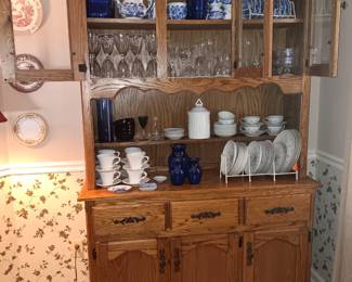 Oak cabinet, china, blue willow, crystal stems.