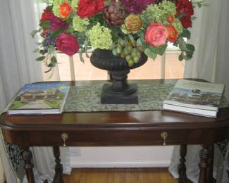 Antique table with exquisite faux floral arrangement, local interest books