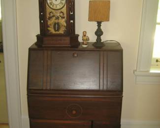 Antique dropleaf desk, clock, and lamp