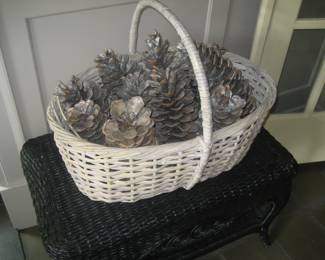 Low black wicker table, basket with pine cones