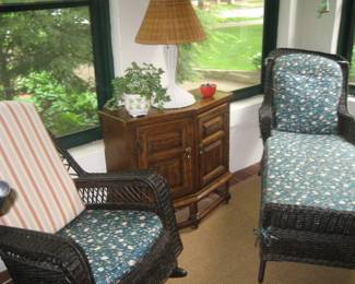 Vintage dark wicker chaise and rocker, wood cabinet, wicker table lamp