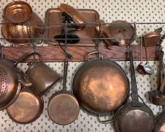 A Large Collection Of Copper Pots Luggage Rack To Hang Them On