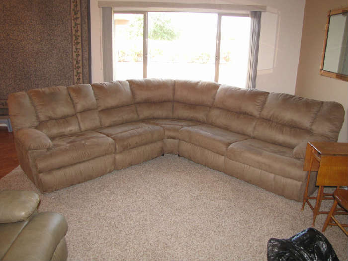 Tan sectional with double recliners and sleeper.